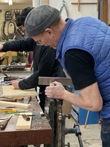 Steven and Rafik work at the bench.