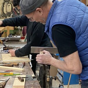 Steven and Rafik work at the bench.